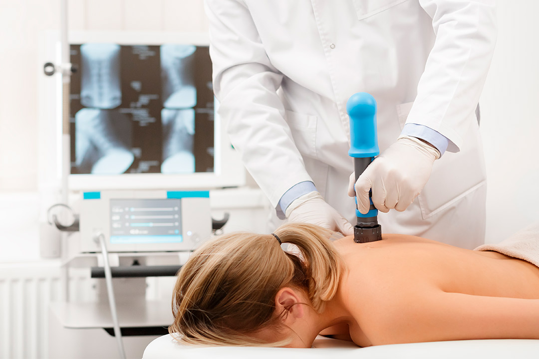 A woman receiving shockwave treatment, highlighting the benefits of extracorporeal therapy