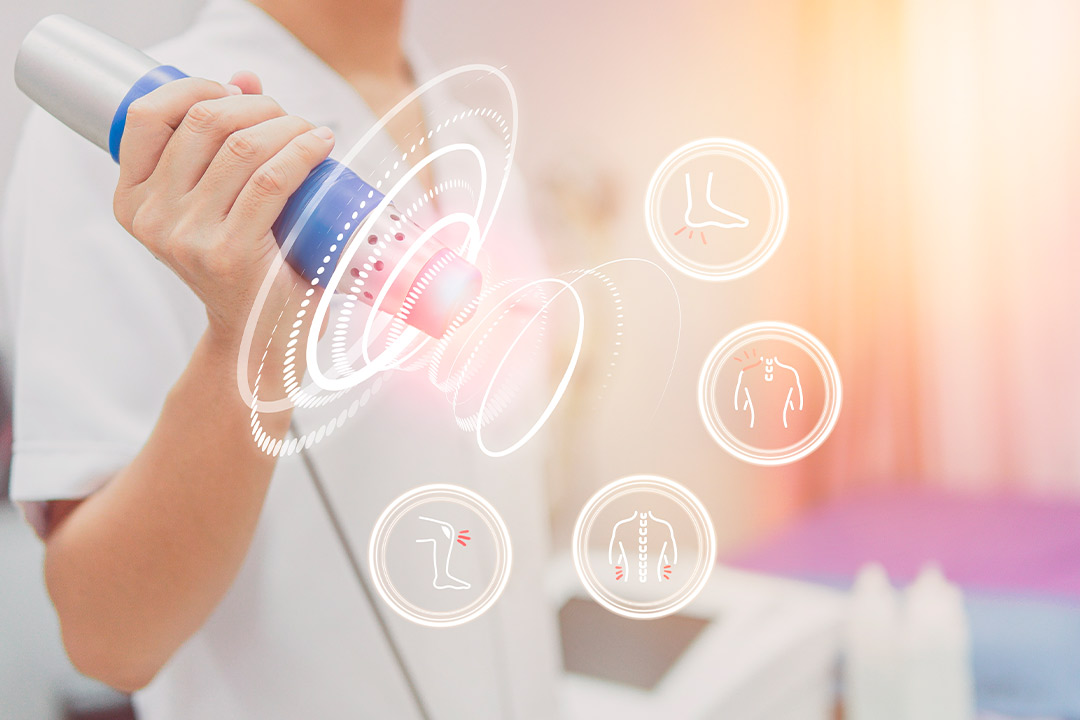 A woman holds a device emitting blue light, symbolizing extracorporeal shockwave therapy certification